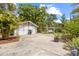 Large backyard with a detached garage, grill, swing, and well-maintained landscaping at 1226 E Henry Ave, Tampa, FL 33604