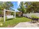 Backyard swing with lawn, landscaping, and a white privacy fence at 1226 E Henry Ave, Tampa, FL 33604