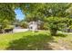 Spacious backyard featuring a well-maintained lawn, patio area, and lush landscaping, ideal for outdoor living and entertaining at 1226 E Henry Ave, Tampa, FL 33604