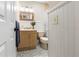Bathroom with a mirror, vanity, floral wallpaper and tiled floor at 1226 E Henry Ave, Tampa, FL 33604