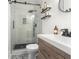Bathroom with modern shower, floating shelves, updated sink, and designer floor at 1226 E Henry Ave, Tampa, FL 33604