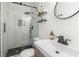 Bathroom with modern shower, floating shelves, updated sink, and designer floor at 1226 E Henry Ave, Tampa, FL 33604
