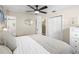 Bedroom featuring hardwood floors, a ceiling fan, a large bed, and an ensuite bathroom at 1226 E Henry Ave, Tampa, FL 33604