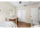 Bright bedroom with two beds, closet and decorative dresser near window at 1226 E Henry Ave, Tampa, FL 33604