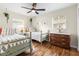 Bright bedroom with two beds, ceiling fan and decorative dresser and chandelier at 1226 E Henry Ave, Tampa, FL 33604