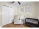 Comfortable Bedroom with glider chair, closet and crib; perfect for a new baby at 1226 E Henry Ave, Tampa, FL 33604