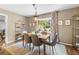 Dining room area with light-filled window, stylish decor, neutral paint, and chandelier at 1226 E Henry Ave, Tampa, FL 33604