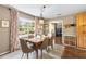Dining area with light-filled window, neutral paint, stylish decor, and access to another living space at 1226 E Henry Ave, Tampa, FL 33604