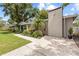 A charming home with a brick chimney, set amidst a lush, green yard and mature trees at 1226 E Henry Ave, Tampa, FL 33604