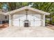 Detached garage with double doors, outdoor lighting, a grill and ample parking space at 1226 E Henry Ave, Tampa, FL 33604