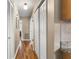 Hallway with a hardwood floor and neutral walls with multiple doors at 1226 E Henry Ave, Tampa, FL 33604