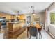 Bright kitchen and dining area with stainless steel appliances, granite countertops, and skylight at 1226 E Henry Ave, Tampa, FL 33604