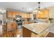 Spacious eat-in kitchen with wood cabinets, granite countertops, stainless steel appliances, and center island at 1226 E Henry Ave, Tampa, FL 33604