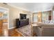 Inviting living area featuring a TV, comfortable seating, and an open transition to the kitchen at 1226 E Henry Ave, Tampa, FL 33604