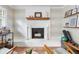 Bright living room featuring a whitewashed fireplace, stylish decor, and access to another seating area at 1226 E Henry Ave, Tampa, FL 33604