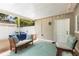 Relaxing screened porch with comfortable seating, stylish outdoor rug, and convenient access to an outdoor door at 1226 E Henry Ave, Tampa, FL 33604
