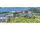 Panoramic aerial view of luxury condos overlooking a golf course and waterfront, offering scenic coastal community living at 125 Belleview Boulevard # 203, Belleair, FL 33756