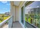 Balcony view overlooking manicured lawn and lush greenery at 125 Belleview Boulevard # 203, Belleair, FL 33756