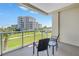 Balcony view overlooking beautiful lawn and tropical trees at 125 Belleview Boulevard # 203, Belleair, FL 33756