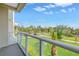 Balcony view overlooking green lawn and palm trees at 125 Belleview Boulevard # 203, Belleair, FL 33756