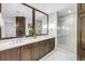 Modern bathroom with dual sinks, quartz countertops, and a glass-enclosed shower at 125 Belleview Boulevard # 203, Belleair, FL 33756