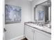 Well-lit powder room with granite counters, modern fixtures, and neutral paint at 125 Belleview Boulevard # 203, Belleair, FL 33756