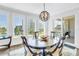 Elegant dining area with hardwood floors and a stylish chandelier, complemented by picturesque views at 125 Belleview Boulevard # 203, Belleair, FL 33756