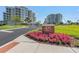 Beautiful condo building with meticulous landscaping and a brick sign at 125 Belleview Boulevard # 203, Belleair, FL 33756