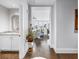 Bright hallway with hardwood floors leading into a tastefully decorated living area, enhanced by coastal views at 125 Belleview Boulevard # 203, Belleair, FL 33756