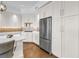 Bright kitchen featuring white cabinets, stainless steel appliances, and a stylish backsplash at 125 Belleview Boulevard # 203, Belleair, FL 33756