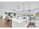 Open floor plan featuring a kitchen island, hardwood floors, and living and dining spaces at 125 Belleview Boulevard # 203, Belleair, FL 33756