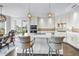 Modern kitchen with island seating, stainless appliances, and stylish backsplash, blending convenience and elegance at 125 Belleview Boulevard # 203, Belleair, FL 33756