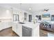Bright, open kitchen with a large island, stainless steel appliances, and hardwood floors at 125 Belleview Boulevard # 203, Belleair, FL 33756