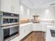 Stylish kitchen featuring stainless steel appliances, double ovens, and modern white cabinetry at 125 Belleview Boulevard # 203, Belleair, FL 33756