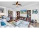 Comfortable living room featuring stylish furnishings, hardwood floors, and an entertainment center for modern living at 125 Belleview Boulevard # 203, Belleair, FL 33756