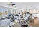 Inviting open-concept living space with modern furnishings, dark hardwood floors, and abundant natural light at 125 Belleview Boulevard # 203, Belleair, FL 33756