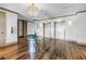 An elegant lobby featuring hardwood floors, modern chandelier, and a contemporary table at 125 Belleview Boulevard # 203, Belleair, FL 33756