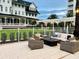 Inviting outdoor patio with cushioned seating and a modern fire pit, perfect for relaxing and entertaining in a grassy area at 125 Belleview Boulevard # 203, Belleair, FL 33756