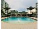 Resort-style pool with cabanas, sun loungers and tropical landscaping, perfect for relaxation at 125 Belleview Boulevard # 203, Belleair, FL 33756