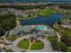 Aerial view showcasing the clubhouse, pool, golf course, and surrounding residential area at 1338 Winding Willow Dr, Trinity, FL 34655