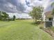 Large, manicured lawn in the backyard with views of the community and bright sky at 1338 Winding Willow Dr, Trinity, FL 34655