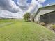 Lush backyard features a well-maintained lawn, mature trees, and a screened lanai, offering a private outdoor space at 1338 Winding Willow Dr, Trinity, FL 34655