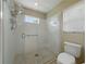 Clean and functional walk-in shower with tiled walls, glass door, window, and modern fixtures at 1338 Winding Willow Dr, Trinity, FL 34655
