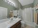 Well-lit bathroom featuring a single sink, modern fixtures, and a shower-tub combination at 1338 Winding Willow Dr, Trinity, FL 34655