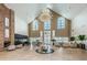 Grand clubhouse interior featuring a soaring ceiling, chandelier, brick fireplace, and ample seating at 1338 Winding Willow Dr, Trinity, FL 34655