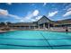 Large community pool with plenty of lounge chairs and umbrellas, perfect for relaxation at 1338 Winding Willow Dr, Trinity, FL 34655
