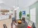 Cozy dining area adjoining kitchen features black table, plants, and ample natural light at 1338 Winding Willow Dr, Trinity, FL 34655
