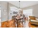 The dining area offers views of the kitchen with an open floor plan and hardwood flooring at 1338 Winding Willow Dr, Trinity, FL 34655