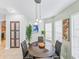 Bright dining area with modern table set, adjacent to kitchen and well-lit by natural light at 1338 Winding Willow Dr, Trinity, FL 34655