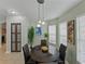 Bright dining area featuring a round table, decorative accents, and natural light from large windows at 1338 Winding Willow Dr, Trinity, FL 34655